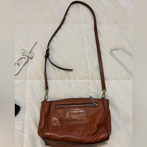 Used but good condition Michael Kors dark tan purse.